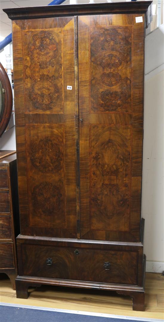 A 1930s walnut wardrobe W.94cm